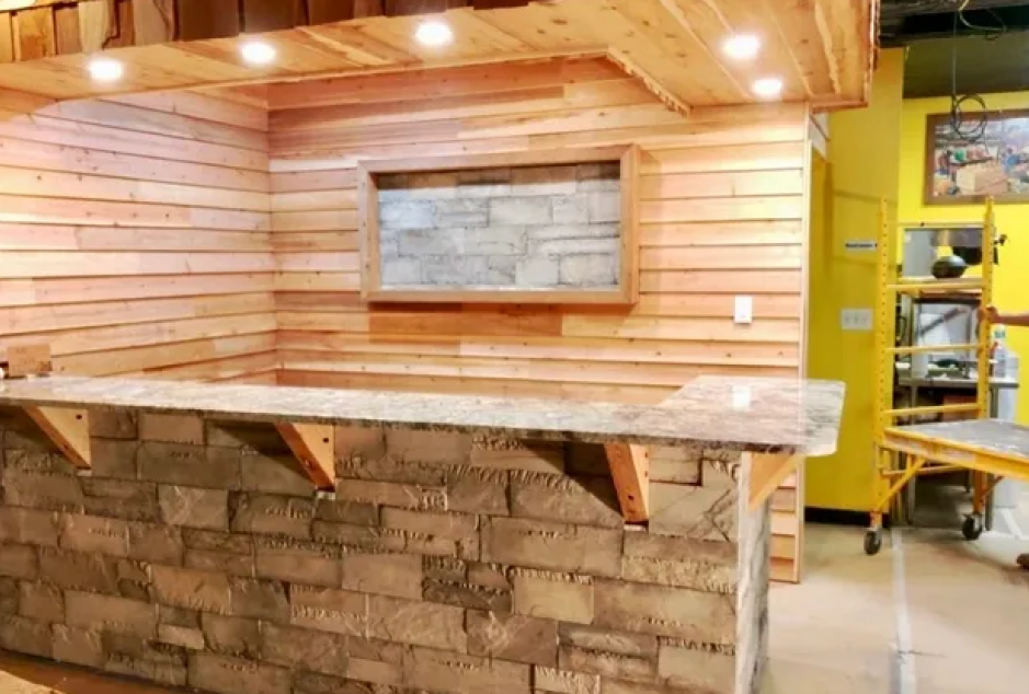 Rustic wooden bar with stone counter.